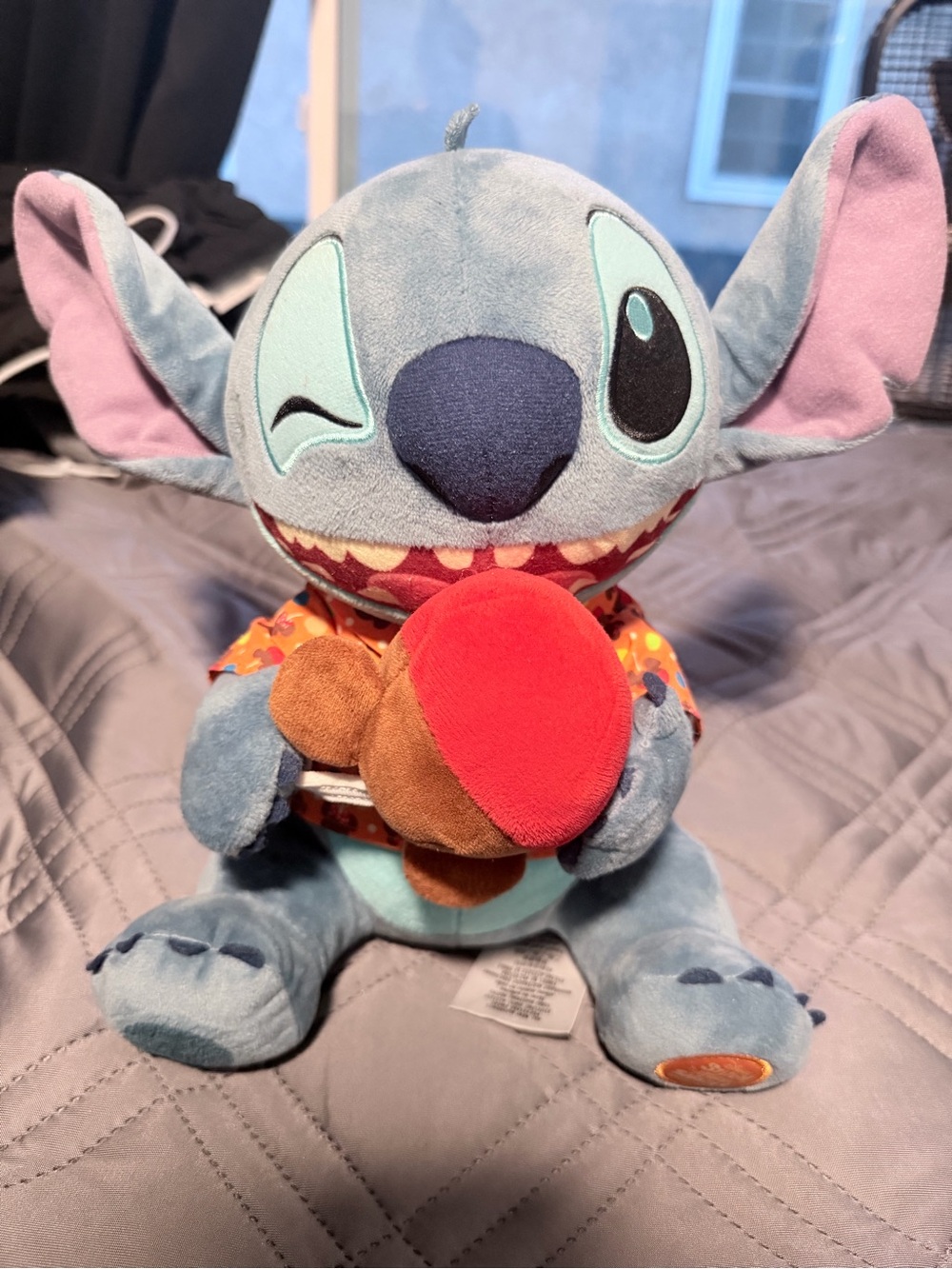 Disney Blue Stitch Plush with Pink Ears Holding Red & Brown Treat
